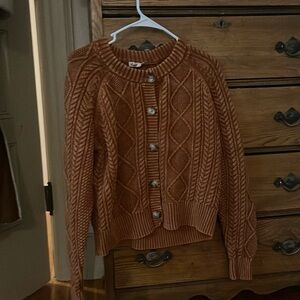 Copper-rusty colored button up sweater.